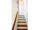 A light and bright staircase with wooden stairs and decorative woodwork at 55 Laurens St # 55-A, Charleston, SC 29401
