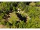 Aerial view of a secluded home with a dark water pond and a long private driveway surrounded by trees at 5680 Dixie Plantation Rd, Hollywood, SC 29449