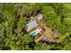 Aerial view of an estate with a pool, garden, fire pit and outdoor lounge area surrounded by lush trees at 5680 Dixie Plantation Rd, Hollywood, SC 29449