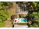 Overhead view of a home with a beautiful pool area, garden, firepit, and lounge chairs at 5680 Dixie Plantation Rd, Hollywood, SC 29449