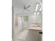 Bright bathroom featuring double sinks, neutral tile, ceiling fan, and shower-tub combination at 5680 Dixie Plantation Rd, Hollywood, SC 29449