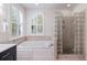 This bathroom boasts a luxurious tub, and a unique glass block shower, providing a spa-like experience at 5680 Dixie Plantation Rd, Hollywood, SC 29449