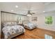 Inviting bedroom with two beds, hardwood floors, and soft lighting, creating a comfortable and relaxing atmosphere at 5680 Dixie Plantation Rd, Hollywood, SC 29449