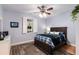 Relaxing bedroom with a ceiling fan, a dark wood bed frame and shutters on the window at 5680 Dixie Plantation Rd, Hollywood, SC 29449