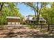Charming brick home with three-car garage, complemented by a neatly fenced yard and mature trees at 5680 Dixie Plantation Rd, Hollywood, SC 29449