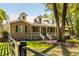 Charming brick home with dormers, lush landscaping and inviting front porch at 5680 Dixie Plantation Rd, Hollywood, SC 29449