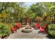 Outdoor fire pit area with stone pavers, Adirondack chairs, and a charming garden shed at 5680 Dixie Plantation Rd, Hollywood, SC 29449