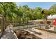 Established vegetable garden surrounded by a privacy fence and mature trees at 5680 Dixie Plantation Rd, Hollywood, SC 29449