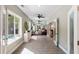 Sunlit hallway with tiled floor, leading to various rooms in the home at 5680 Dixie Plantation Rd, Hollywood, SC 29449