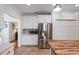 Bright eat-in kitchen with a stainless steel refrigerator, an island, and white cabinets at 5680 Dixie Plantation Rd, Hollywood, SC 29449