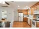 Bright kitchen with wooden cabinets, white appliances, and hardwood floors, creating a functional and inviting space at 5680 Dixie Plantation Rd, Hollywood, SC 29449
