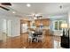 Open kitchen area with hardwood floors, ceiling fan, eat-in table with chairs, and window views at 5680 Dixie Plantation Rd, Hollywood, SC 29449