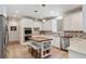 Bright eat-in kitchen with an island, white cabinets, stainless steel appliances, and designer backsplash at 5680 Dixie Plantation Rd, Hollywood, SC 29449