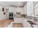 Bright eat-in kitchen with stainless steel appliances, white cabinets, and designer backsplash at 5680 Dixie Plantation Rd, Hollywood, SC 29449