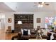 Spacious living room with a leather sofa, dark wood bookcase, and dining room access at 5680 Dixie Plantation Rd, Hollywood, SC 29449