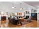 Spacious living room features two sofas, a fireplace, ceiling fans, and hardwood floors at 5680 Dixie Plantation Rd, Hollywood, SC 29449