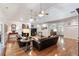 Spacious living room features two sofas, a fireplace, ceiling fans, and hardwood floors at 5680 Dixie Plantation Rd, Hollywood, SC 29449