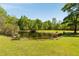 Scenic pond surrounded by lush greenery with clear blue skies at 5680 Dixie Plantation Rd, Hollywood, SC 29449