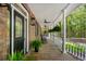Relaxing front porch with rocking chairs and lush greenery, perfect for enjoying the outdoors at 5680 Dixie Plantation Rd, Hollywood, SC 29449