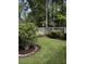 Lush backyard with manicured shrubs and garden beds, surrounded by a wooden fence at 5691 Captain Kidd Rd, Hollywood, SC 29449