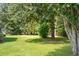 Spacious backyard featuring mature trees and manicured lawn at 5691 Captain Kidd Rd, Hollywood, SC 29449