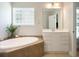 This bathroom features a soaking tub, a mirror and vanity and unique decor at 5691 Captain Kidd Rd, Hollywood, SC 29449