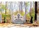 Royal Harbour entrance featuring a stone sign with a pineapple motif and established landscaping at 5691 Captain Kidd Rd, Hollywood, SC 29449