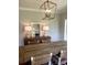 This dining room boasts a wooden table, a mirror, lamps and a light fixture that accentuates the space at 5691 Captain Kidd Rd, Hollywood, SC 29449