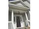 Close-up of the front porch featuring classic white columns and a stylish entrance, adding charm and elegance at 5691 Captain Kidd Rd, Hollywood, SC 29449