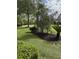 Well-maintained front yard with fresh mulch, lush green grass, and mature landscaping at 5691 Captain Kidd Rd, Hollywood, SC 29449