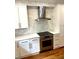 Close-up of a modern kitchen featuring stainless steel appliances, quartz countertops, and elegant backsplash at 5691 Captain Kidd Rd, Hollywood, SC 29449