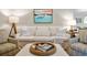 This living room features a white sofa, an artistic boat painting, comfortable seating and decor at 5691 Captain Kidd Rd, Hollywood, SC 29449