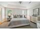 This primary bedroom features large windows, a ceiling fan and neutral decor at 5691 Captain Kidd Rd, Hollywood, SC 29449