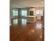 Open concept living area featuring a modern kitchen, dining area, and abundant natural light from large windows at 5691 Captain Kidd Rd, Hollywood, SC 29449