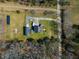 Large rural property with a house, outbuildings, solar panels, and a long driveway surrounded by forest at 6440 St Anthony Dr, Hollywood, SC 29449