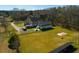 A spacious home and property featuring outbuildings, parking for RV, solar panels, and large grass lawns at 6440 St Anthony Dr, Hollywood, SC 29449