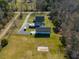 A large property with a home, outbuildings, long driveway, and spacious lawn surrounded by trees at 6440 St Anthony Dr, Hollywood, SC 29449