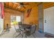 Covered back porch area featuring a table and chairs with an American flag hanging above at 6440 St Anthony Dr, Hollywood, SC 29449
