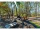 Backyard fire pit with Adirondack chairs under the trees at 6440 St Anthony Dr, Hollywood, SC 29449