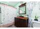 Bathroom with dark wood vanity and a shower/tub with a patterned curtain at 6440 St Anthony Dr, Hollywood, SC 29449