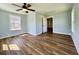 Bright bedroom with hardwood flooring, ceiling fan and natural light from the window at 6440 St Anthony Dr, Hollywood, SC 29449