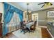 Dining room with chandelier and hardwood floors featuring blue drapes at 6440 St Anthony Dr, Hollywood, SC 29449