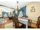 Elegant dining room with blue drapes and hardwood floors adjacent to the living room at 6440 St Anthony Dr, Hollywood, SC 29449