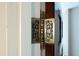 Close-up of an ornate vintage-style brass door hinge against a white and wood door frame at 6440 St Anthony Dr, Hollywood, SC 29449