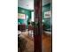 Close up of the beveled green glass doorknob of a classic dark wooden door with a view into an office at 6440 St Anthony Dr, Hollywood, SC 29449
