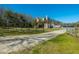 Charming two-story home featuring a spacious lot, wooden fence, and a long driveway leading to the residence at 6440 St Anthony Dr, Hollywood, SC 29449