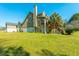 Rear exterior view of a well-maintained home with a large yard, showcasing its architectural details at 6440 St Anthony Dr, Hollywood, SC 29449