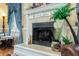 Close-up of the fireplace with decorative tile, greenery, and a white mantel at 6440 St Anthony Dr, Hollywood, SC 29449