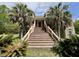 Inviting front entrance featuring a grand staircase, stone accents, and lush landscaping with mature trees at 6440 St Anthony Dr, Hollywood, SC 29449