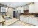 Granite countertops and a stainless steel refrigerator complete the kitchen at 6440 St Anthony Dr, Hollywood, SC 29449